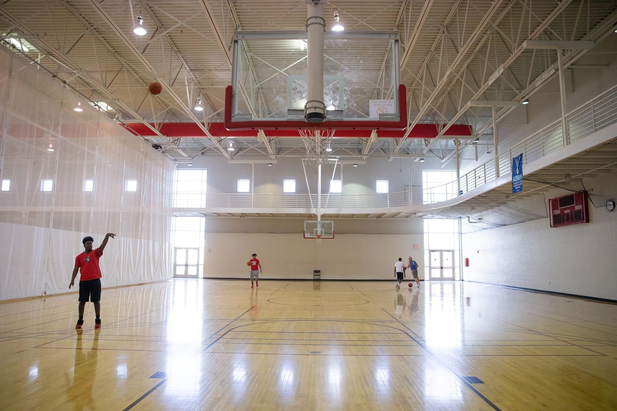 student shooting hoops on foy basketball court